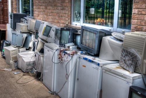 Professional clearing a cluttered garage in Millbank