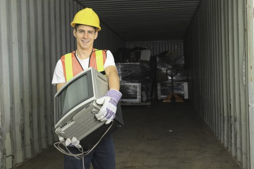 Workers managing construction debris during waste clearance