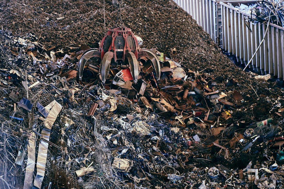 Close-up view of a pile of crushed aluminum cans and metal food tins, with some cans slightly dented and exhibiting a shiny, reflective silver surface, while the tins have a smooth, matte finish in go